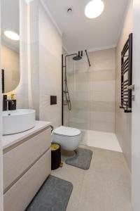 a bathroom with a sink and a toilet and a shower at Relax Blue VOGH in Olimp +31 photos
