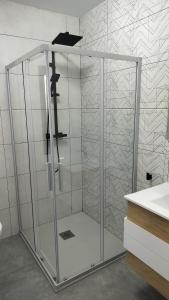a glass shower in a bathroom with a sink at LOVE Rural in La Mata de Morrella +39 photos
