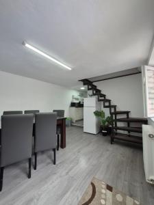 an office with a table and chairs and a staircase at Apartament Magnolia Nearby City Center With Parking in Sibiu +27 photos