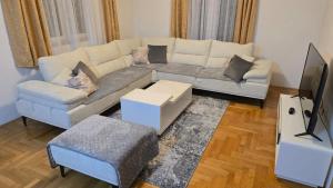 a living room with a couch and a tv at Village Villa in Bijelo Polje