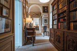 a hallway with a library with a desk and bookshelves at 19-4 Union Street in Edinburgh