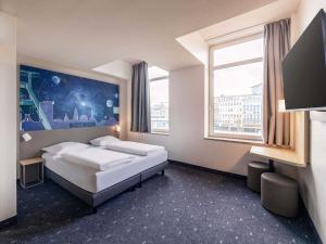 Postel nebo postele na pokoji v ubytování B&B HOTEL Bochum Hbf-Nord
