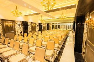a room with rows of chairs and chandeliers at Shera Hotels & Banquets in Navi Mumbai