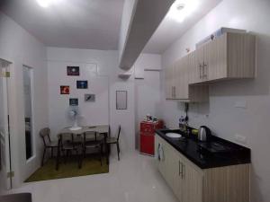 a kitchen with a table and a dining room at RCL Homestay condo unit in Mactan Island
