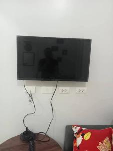 a flat screen tv hanging on a wall at RCL Homestay condo unit in Mactan Island