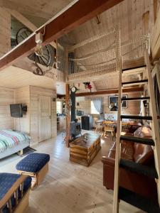 a room with bunk beds and a living room at Wilderness cottage 6 people in Kiruna