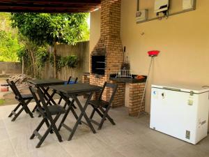 a patio with a table and chairs and a fireplace at Sítio Jean Barros in Meruoca +13 photos
