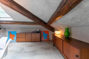 a living room with wooden cabinets and a table at L'attico del Centro - Luxury Penthouse in Como Center in Como