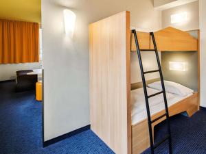 a bunk bed with a ladder in a room at B&B HOTEL Frankfurt-Hbf in Frankfurt/Main