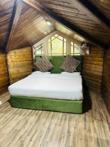 a bedroom with a large bed in a small room at Lidder view The best River side Resort in Pahalgam in Pahalgām