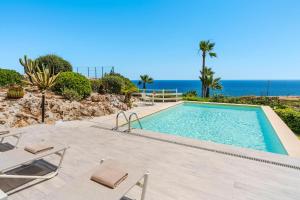 a swimming pool with a view of the ocean at Villa del Mito in Plemmirio +62 photos