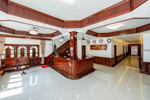 a large lobby with wood paneling and a staircase at LUANGPRABANG CENTER Hotel in Luang Prabang +117 photos