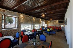 a restaurant with tables and chairs in a room at Anemos Suites Mani 