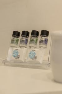 a shelf with four bottles of moisturizers on it at Aloni Suites Pollonia in Pollonia