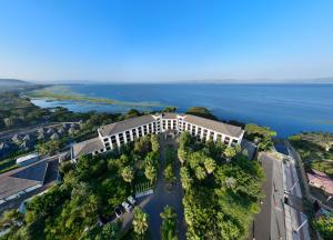 an aerial view of a building on a hill next to the water at Haile Resort Hawassa in Āwasa
