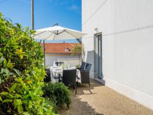 a table with an umbrella on a patio at Apartman Chilli in Dramalj