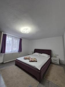 a bedroom with a bed and a ceiling with a light at Apartament Magnolia Nearby City Center With Parking in Sibiu