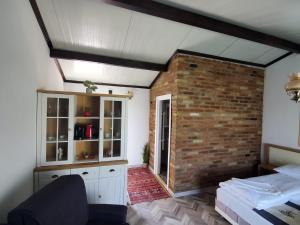 a room with a brick wall and a room with a bed at ARCADIA Village in Merei