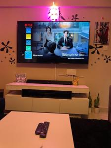 a living room with a flat screen tv on a wall at Olivia homes in Nairobi