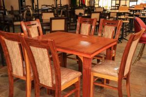 a wooden table and chairs in a restaurant at Lake Naivasha Lazarus Lodge in Naivasha