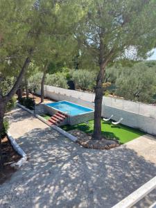 a swimming pool in a yard with trees at Sant'Angelo Country House in Trani