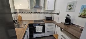 a small kitchen with a sink and a stove at Let's RelaxX 2-Rooms in Mülheim an der Ruhr