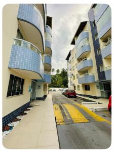 a view of a street with two buildings and a car at AP zona sul Ilhéus in Ilhéus +7 photos