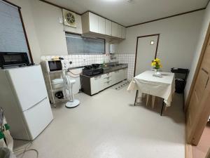 大津アパート一室堅田駅徒歩10分貸切可能的带桌子和冰箱的小厨房 更多2张照片