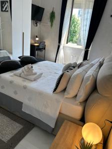 a bedroom with a bed with pillows and a window at Loft NUOVO vicino al centro - OASI Relax in Turin