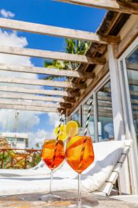 two glasses of orange juice sitting on a table at ZAN Sun Beach in Makunduchi