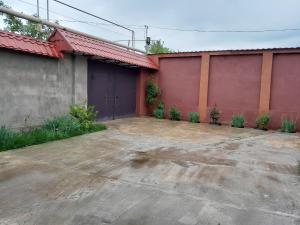 an empty parking lot in front of a building at Quba Cozy House in Amsar