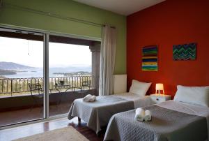a bedroom with two beds and a balcony at Casa T with landscape views in Kontokali +46 photos