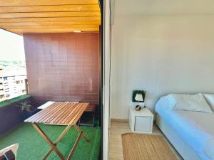 a small room with a bed and a table at APART CityMar 24h in Vigo +12 photos