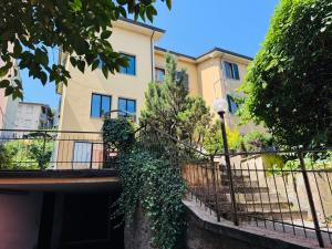 a building with a fence and a street light at Casa Lenzi Porretta in Porretta Terme
