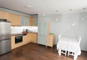 a kitchen with a table and a table and chairs at Portlight Apartment -at Marina Yacht Park, Old Town Gdynia in Gdynia