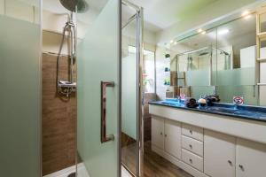 a bathroom with a sink and a shower at Le Chêne des Loges - Campagne - Familial in Bouère