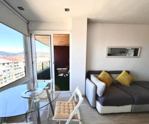 a living room with a couch and a glass table at APART CityMar 24h in Vigo
