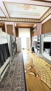 a room with bunk beds and a rug on the floor at Veluna Inn Hostel & Hotel in Baku