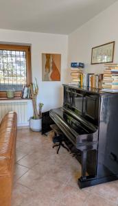 a living room with a piano and a couch at Serenissima in Monfalcone