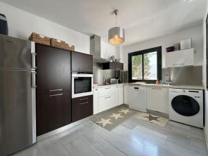 a kitchen with a refrigerator and a dishwasher at MARINA 24 by SOM Menorca in Fornells