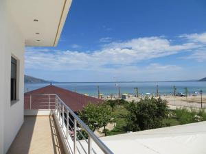 a balcony with a view of a beach and the ocean at Kompleksi Turistik EDIR in Orikum