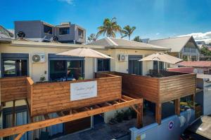 a building with two decks with umbrellas on it at T3 - 100m2 - Résidence Georgette in Terre Sainte
