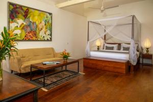 a living room with a bed and a couch at No 50 Lighthouse Street in Galle