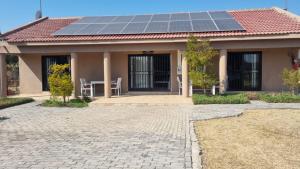 a house with solar panels on the roof at Lanseria FlyCom in Lanseria Airport (Johannesburg)