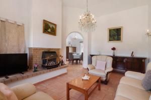 a living room with a fireplace and a tv at Sun Set Pôr Do Sol in Guia