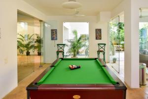 a pool table in the middle of a room with afits at La Mer by The Blue Kite - Pool, Kitchen, Pool Table, Wifi & Security, 10 mins to Candolim Beach & 5 mins to Casino in Nerul