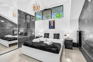 a bedroom with a bed with two pillows on it at Luxury House Jacuzzi - Milano in Milan