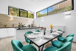 a dining room with a table and green chairs at Luxury House Jacuzzi - Milano in Milan +21 photos