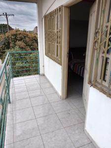 a balcony with a door and a room with a bed at Recidencial nube69 in Santa Cruz de la Sierra
