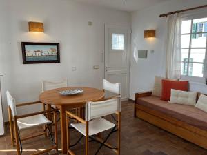 a living room with a table and a couch at ES CASTELL 1 1 by SOM Menorca in Fornells